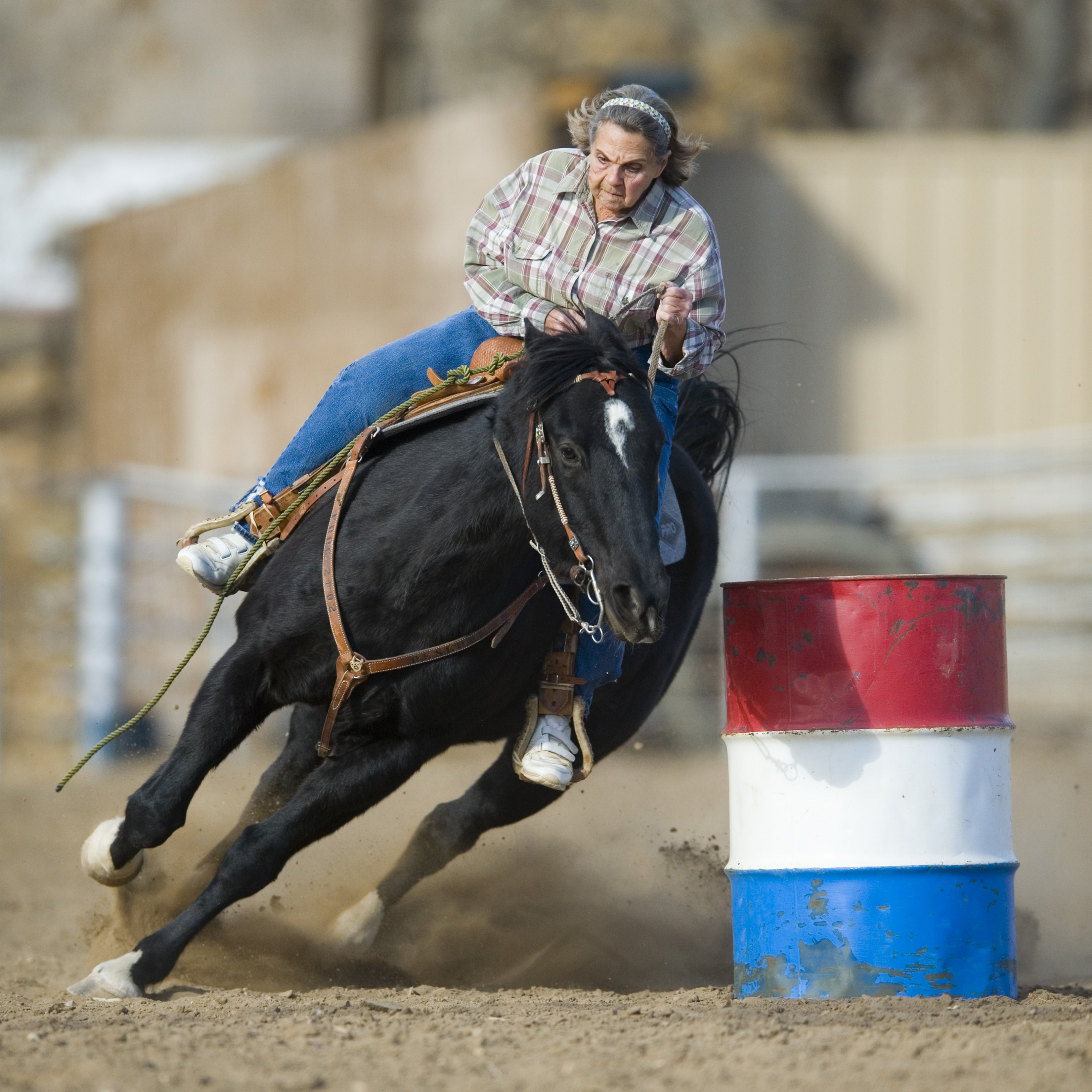 Ardith Bruce, 81, rounds a barrel in the arena at Fountain's Metcalf Park Monday, December 3, 2012. Photo by Mark Reis, The Gazette