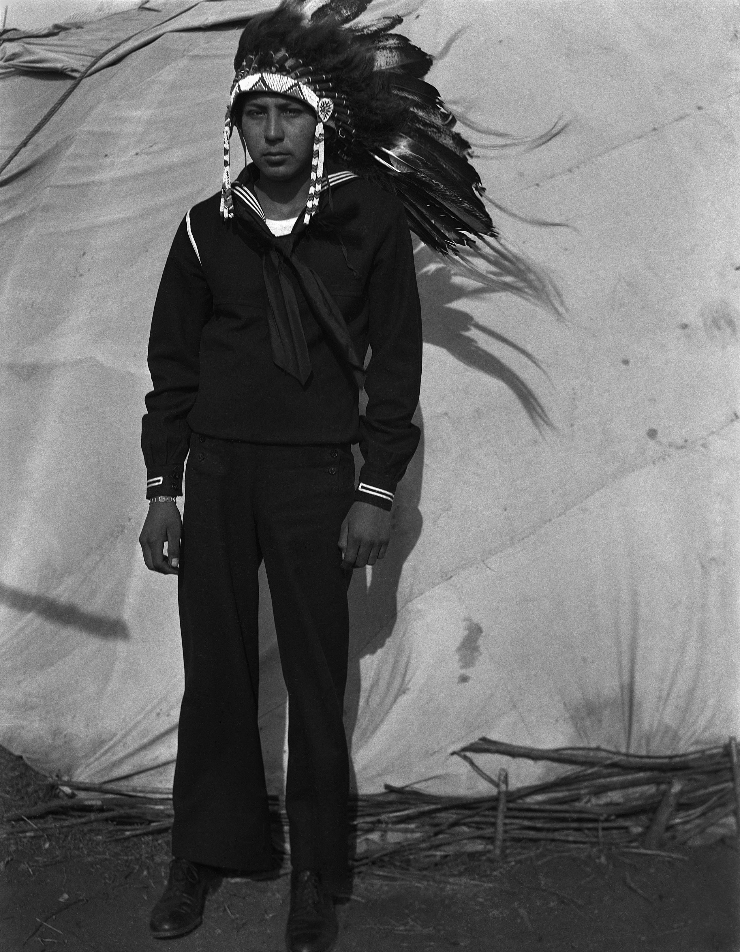 Photography: Jerry Poolaw (Kiowa) on leave from duty in the Navy. Anadarko, Oklahoma, ca. 1944. Courtesy the Estate of Horace Poolaw