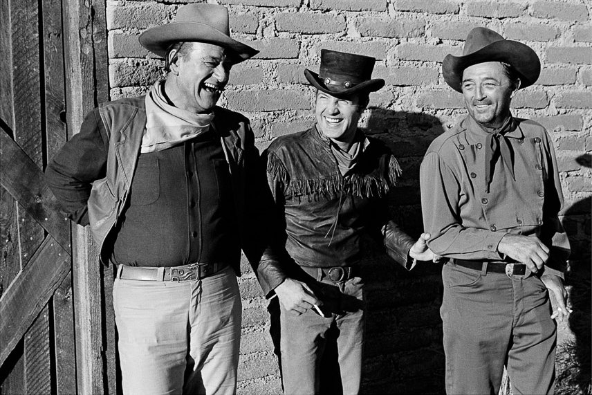  John Wayne, James Caan, and Robert Mitchum laughing on the set of "El Dorado" (1966). Photography: Courtesy John Wayne Enterprises