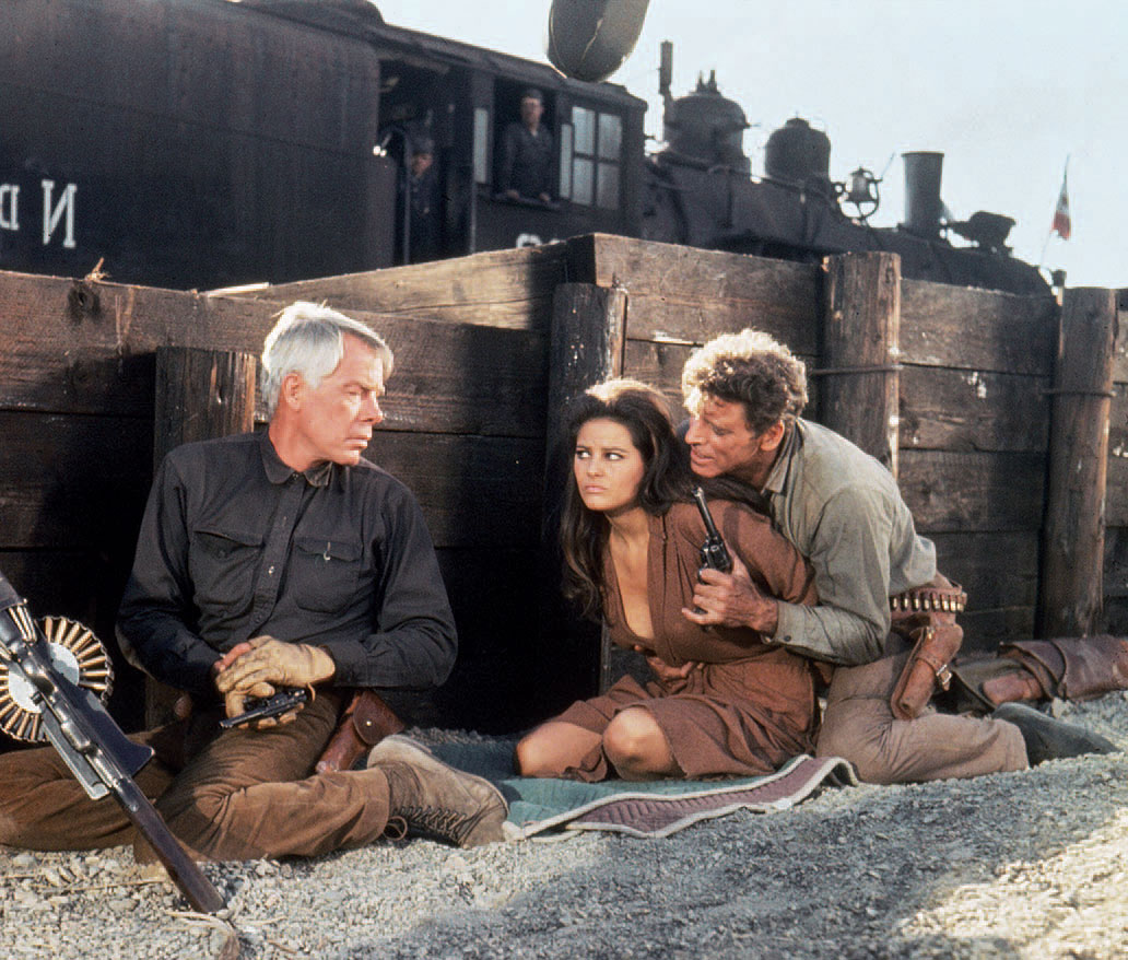 Marvin and his team (including Lancaster) are hired by a wealthy rancher to rescue his kidnapped wife (Cardinale). Photography: Columbia Pictures/Photofest