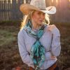 Blonde woman with cowgirl hat posing in her Fringe Scarf, Kingman Turquoise.