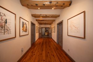 The main hallway of the Kokopelli Main ranch, showcasing a log cabin-esque interior with rustic finishes.