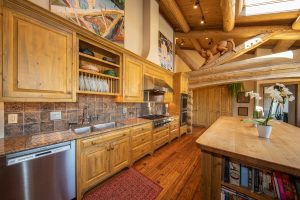 The open-concept kitchen of the Kokopelli Ranch house features a large island and all necessary amenities.