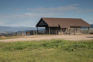 The private barn of the Kokopelli Ranch property which leads to a grazing field, overlooking the Montana mountains.