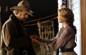 Actress Annette Bening clasps hands with actor Kevin Costner in the 2003 film "Open Range."