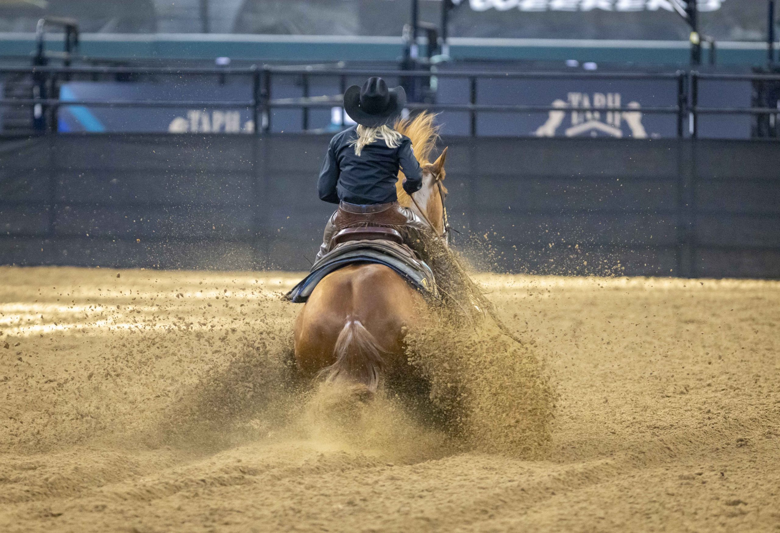 Sarah Dawson comes to a sliding stop with her equine partner at the Globe Life Field arena.