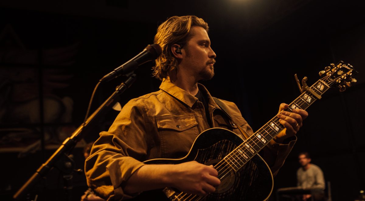 Luke Grimes performing music onstage