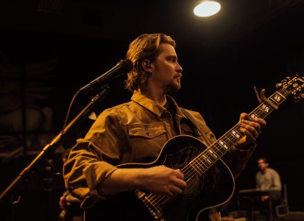Luke Grimes performing music onstage