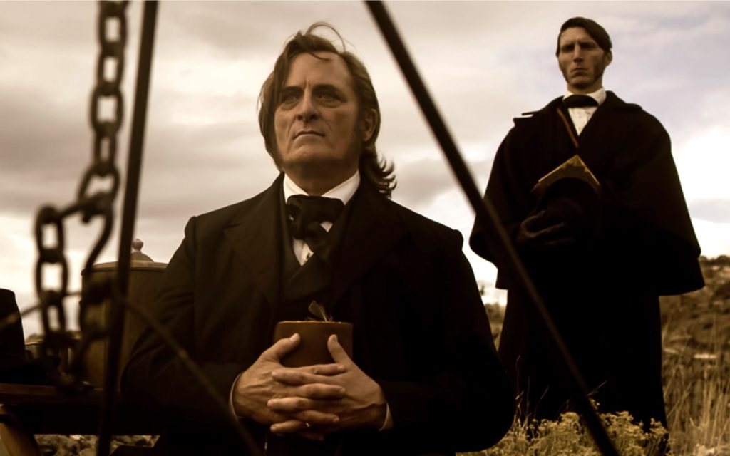 Kim Coates as Brigham Young and Alex Breaux as Wild Bill Hickman in "American Primeval"