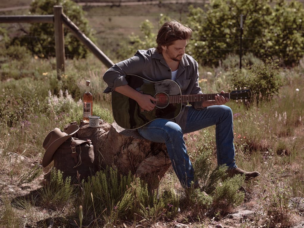 Luke Grimes playing guitar