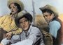Actors Elizabeth Taylor (left), Rock Hudson (middle), and James Dean (right) pose in classic cowboy and cowgirl outfits in the 1956 film "Giant."